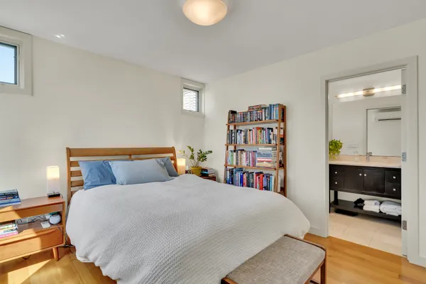 a bed room with a bed and a book shelf
