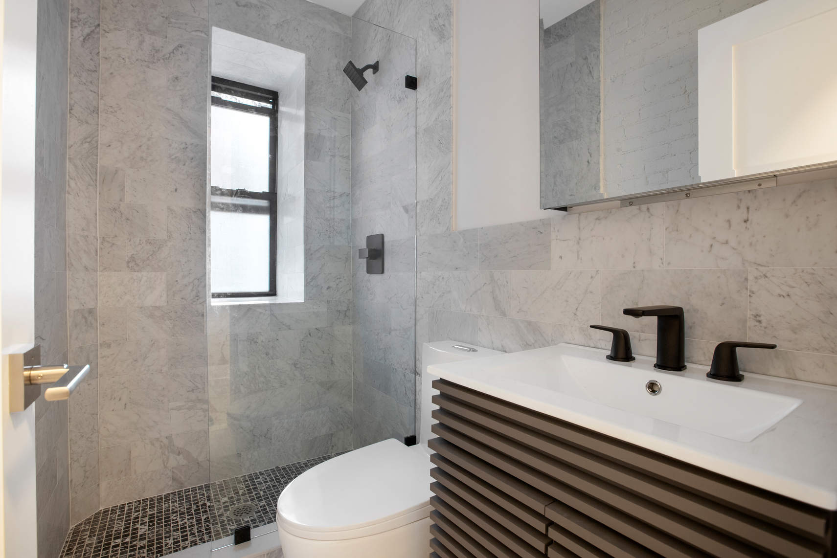 1392 Madison Avenue, Unit 24 Manhattan, NY 10128 - Photo 3 of 6 a bathroom with a sink toilet and shower