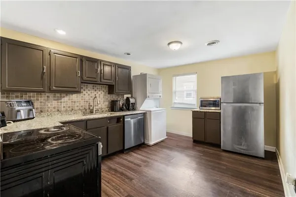 a kitchen with a refrigerator stove and a sink