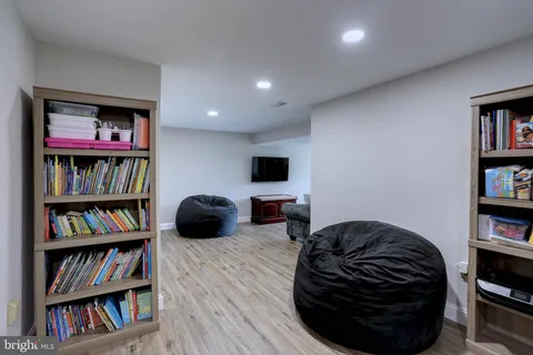 a view of a workspace with furniture and wooden floor