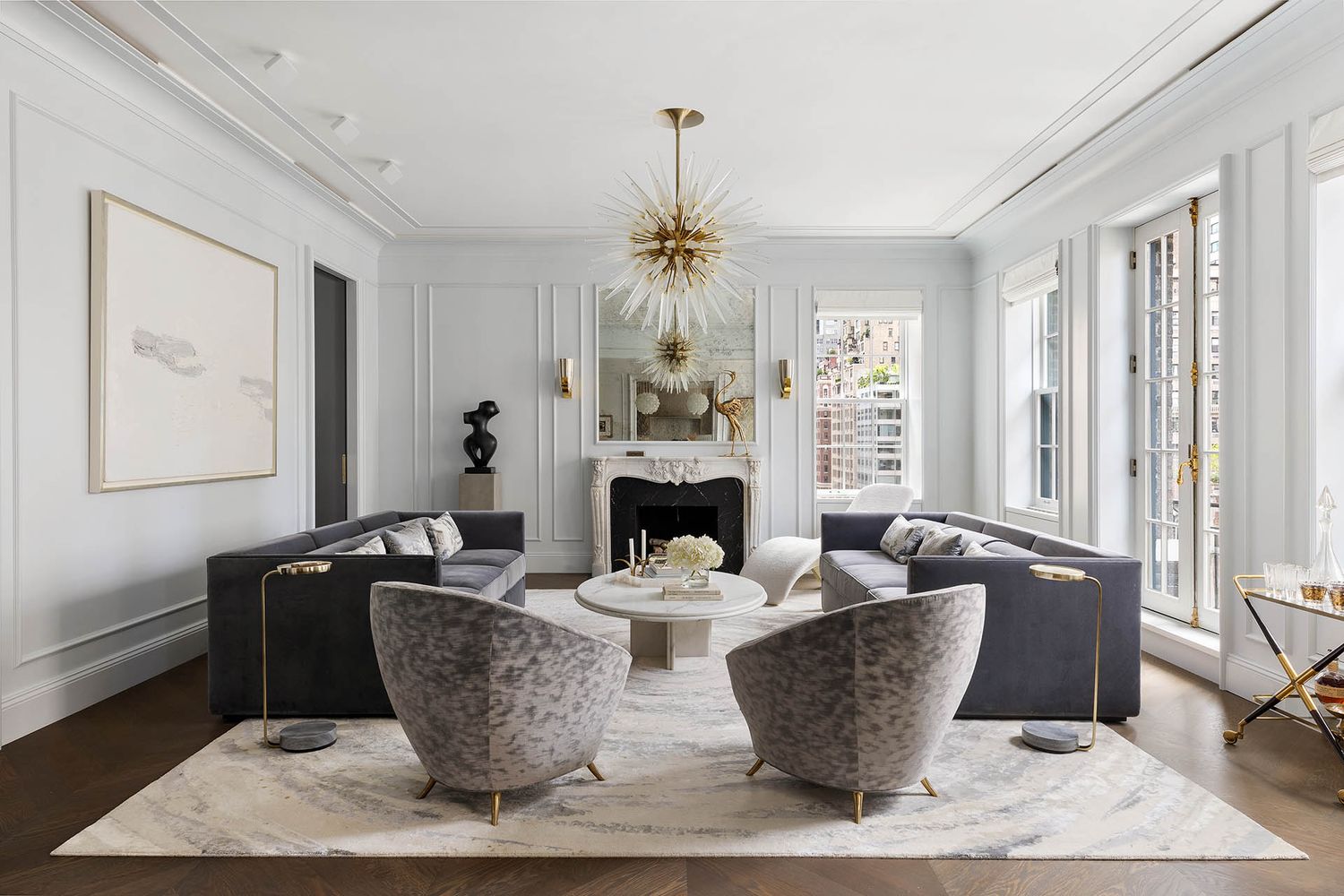 a living room with fireplace furniture and a chandelier