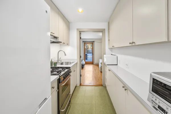 a kitchen with granite countertop a stove and a sink
