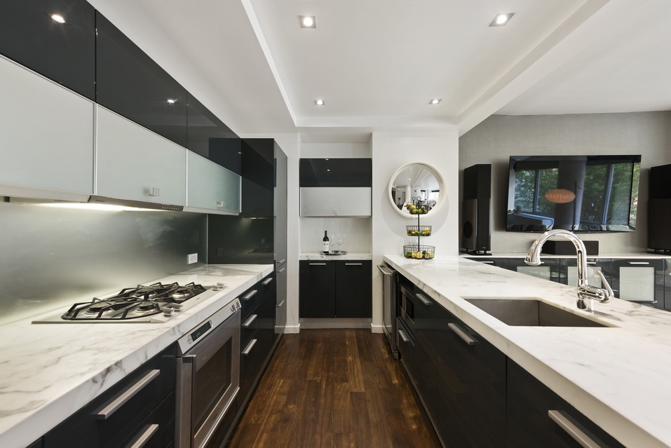 444 West 19th Street, Unit 201 Manhattan, NY 10011 - Photo 4 of 13 a kitchen with a sink stove and cabinets