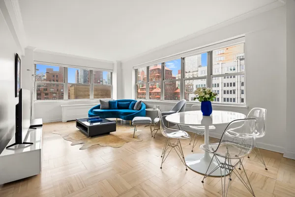 a living room with furniture and floor to ceiling windows
