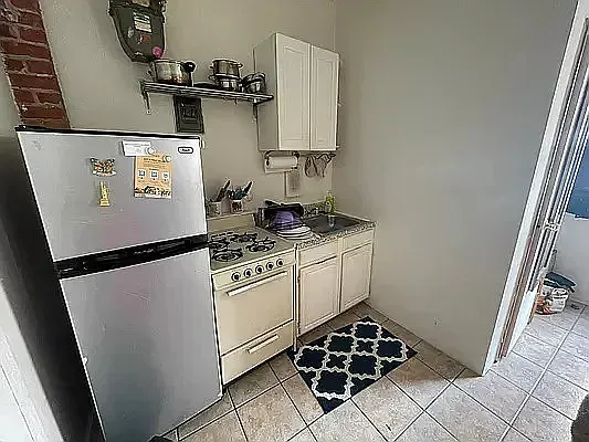 a white refrigerator freezer sitting inside of a kitchen