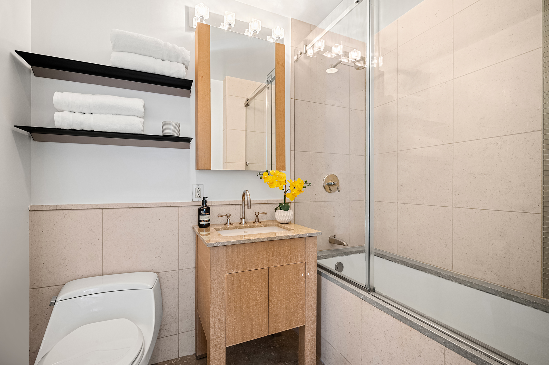 350 West 42nd Street, Unit 20G Manhattan, NY 10036 - Photo 7 of 27 a bathroom with a sink toilet and shower
