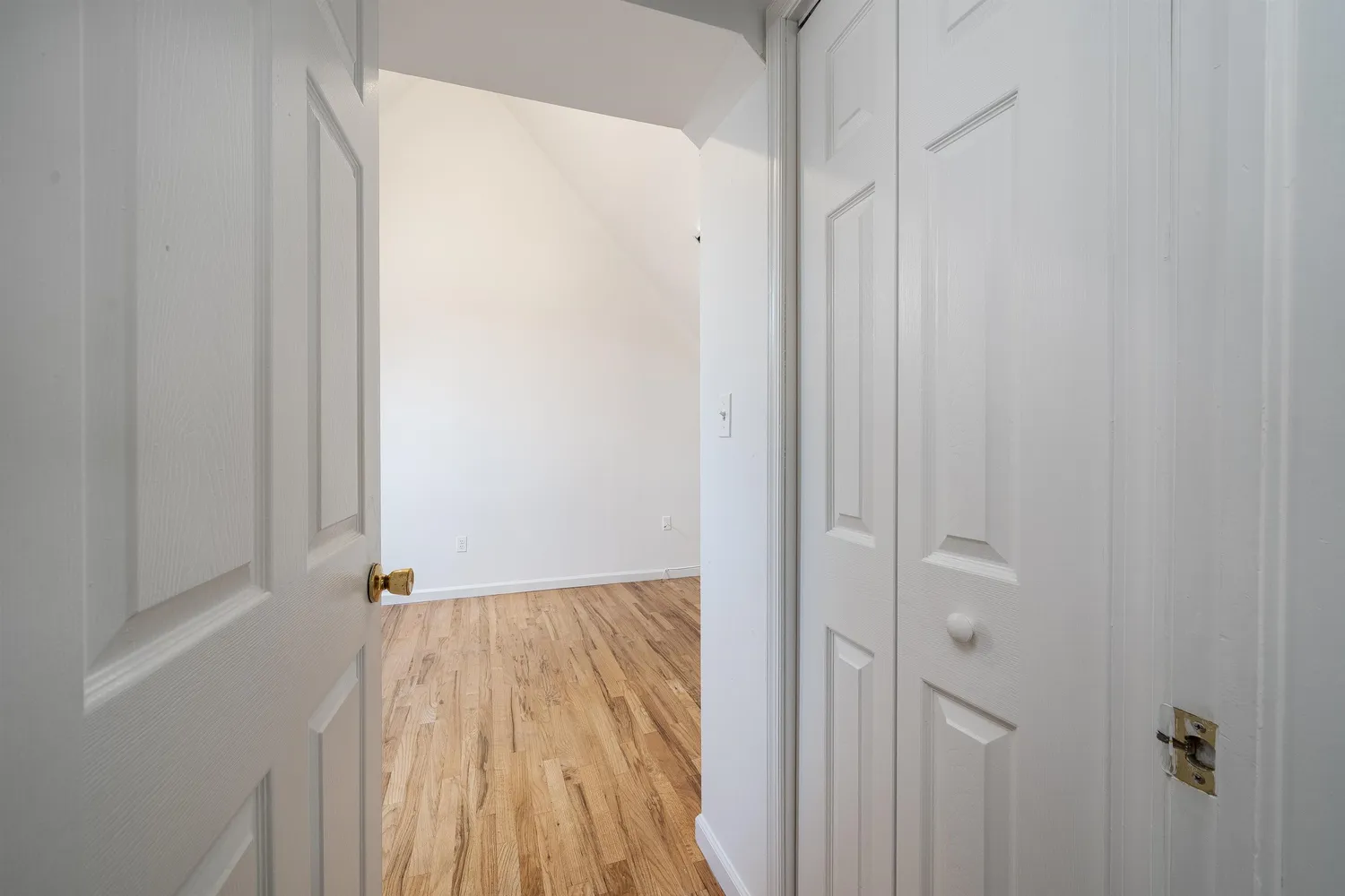 a view of a room with wooden floor
