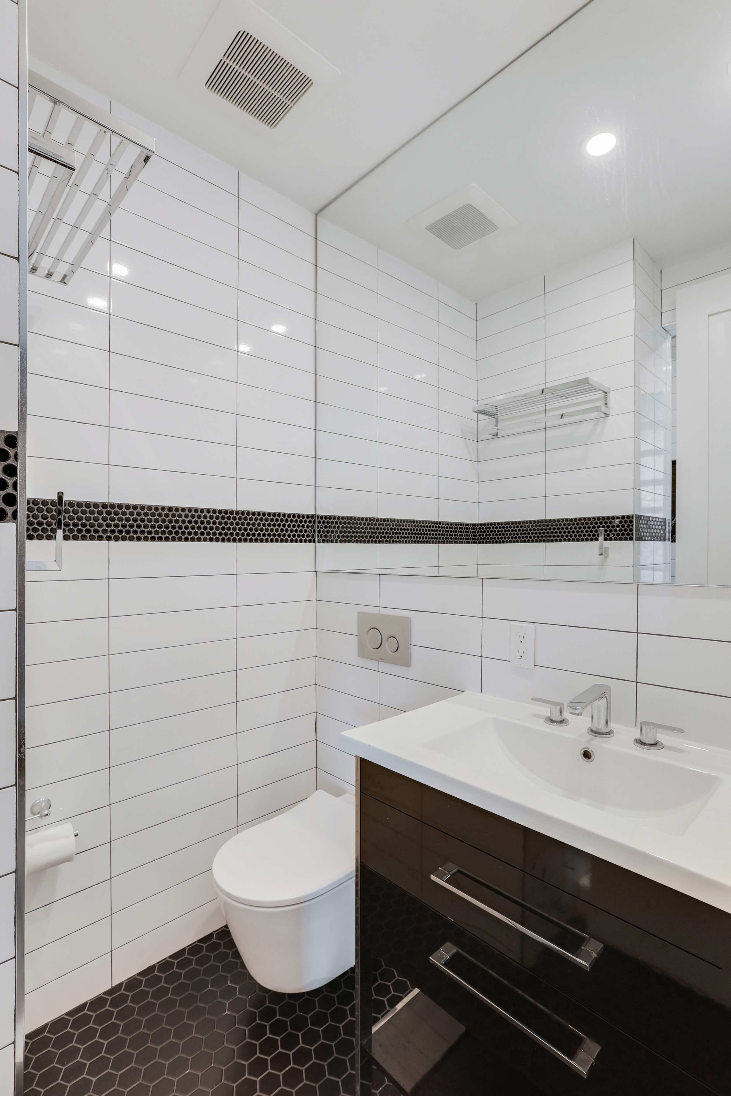 252 East 7th Street, Unit 7/8 Manhattan, NY 10009 - Photo 12 of 13 a bathroom with a sink mirror and toilet