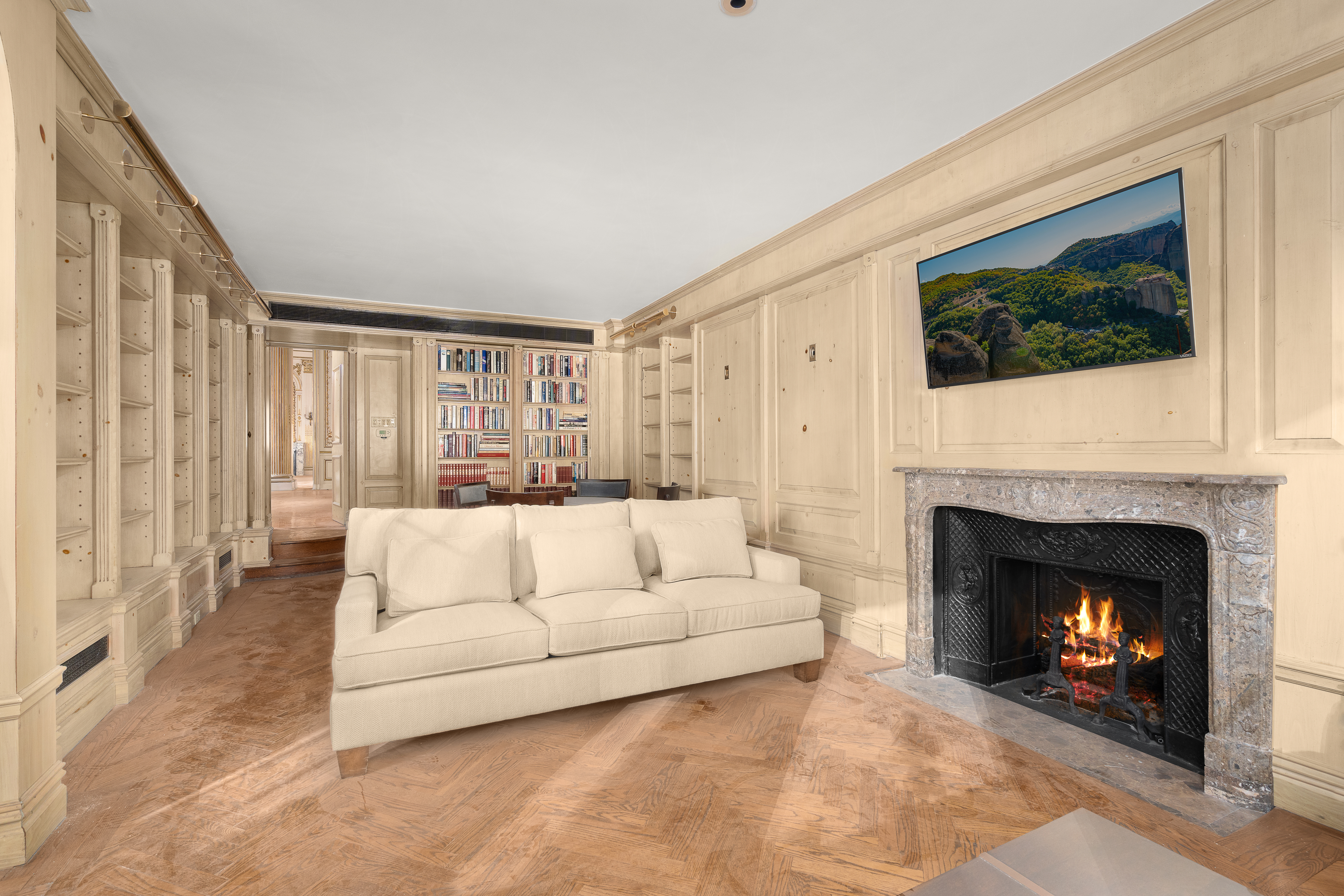 1 East 62nd Street, Unit PH Manhattan, NY 10065 - Photo 12 of 13 a living room with furniture a flat screen tv and a fireplace