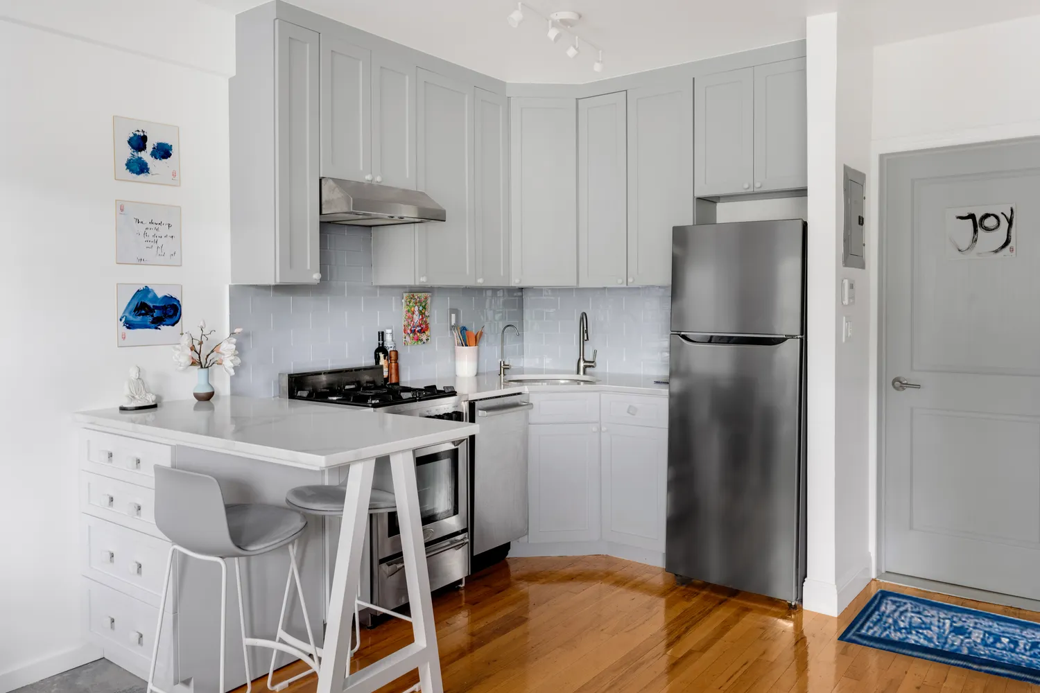 a kitchen with a refrigerator and a stove top oven