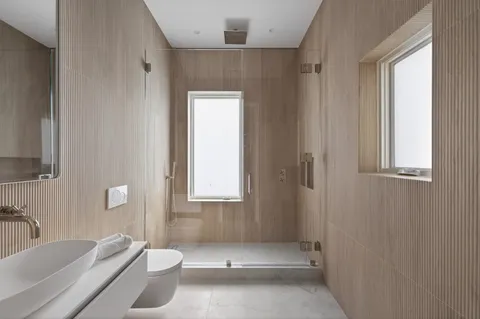 a bathroom with a tub a sink and a window
