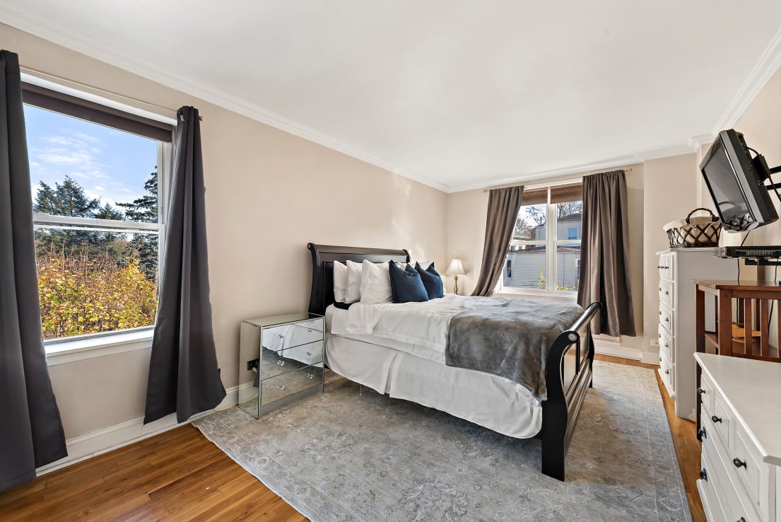 5730 Mosholu Avenue, Unit 4F Bronx, NY 10471 - Photo 13 of 15 a bedroom with a bed lamps and wooden floor