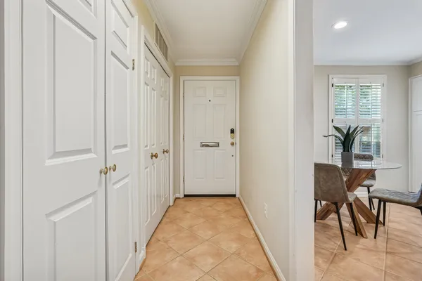 a view of a hallway with wooden floor and dining room