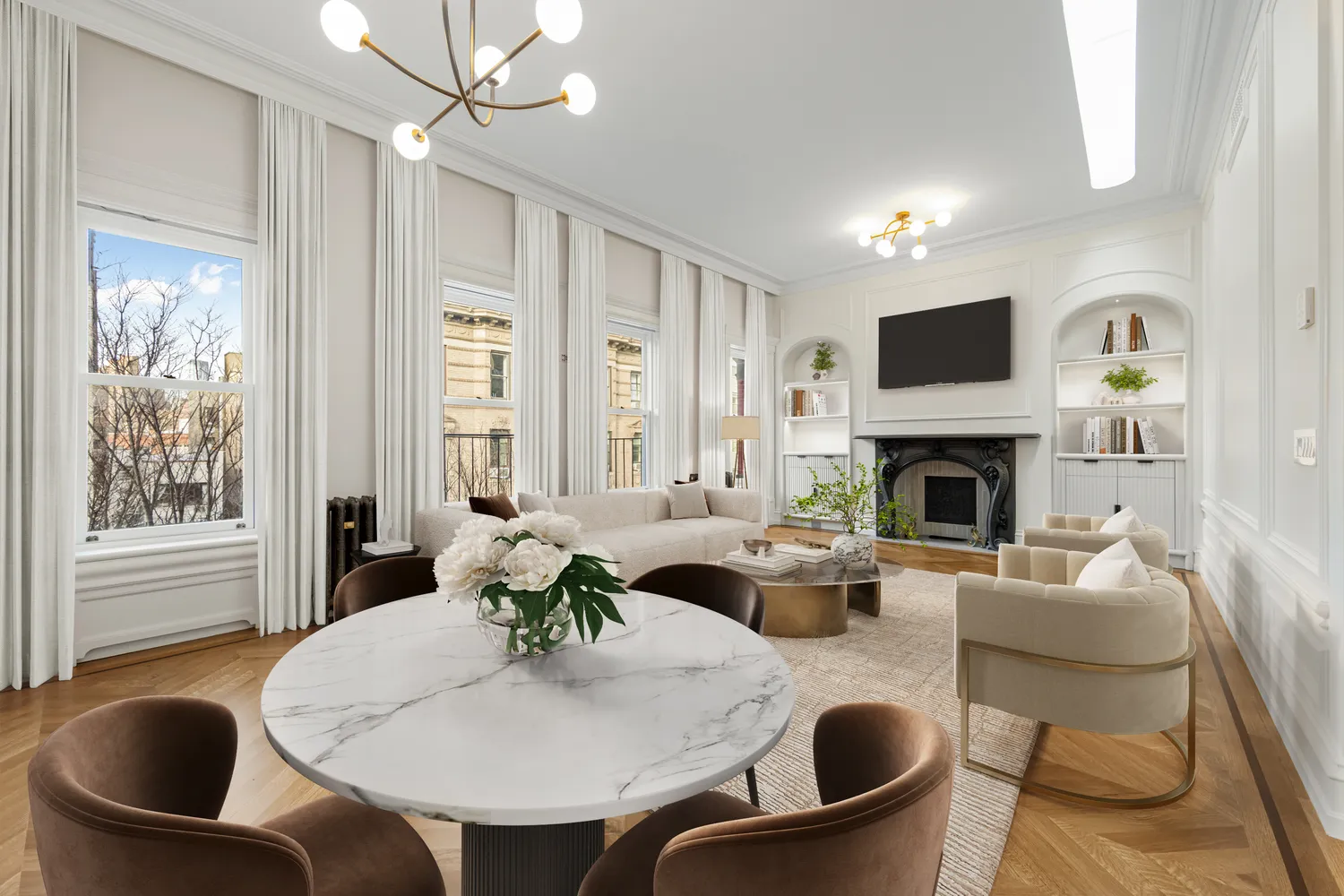 a living room with furniture a fireplace and a large window