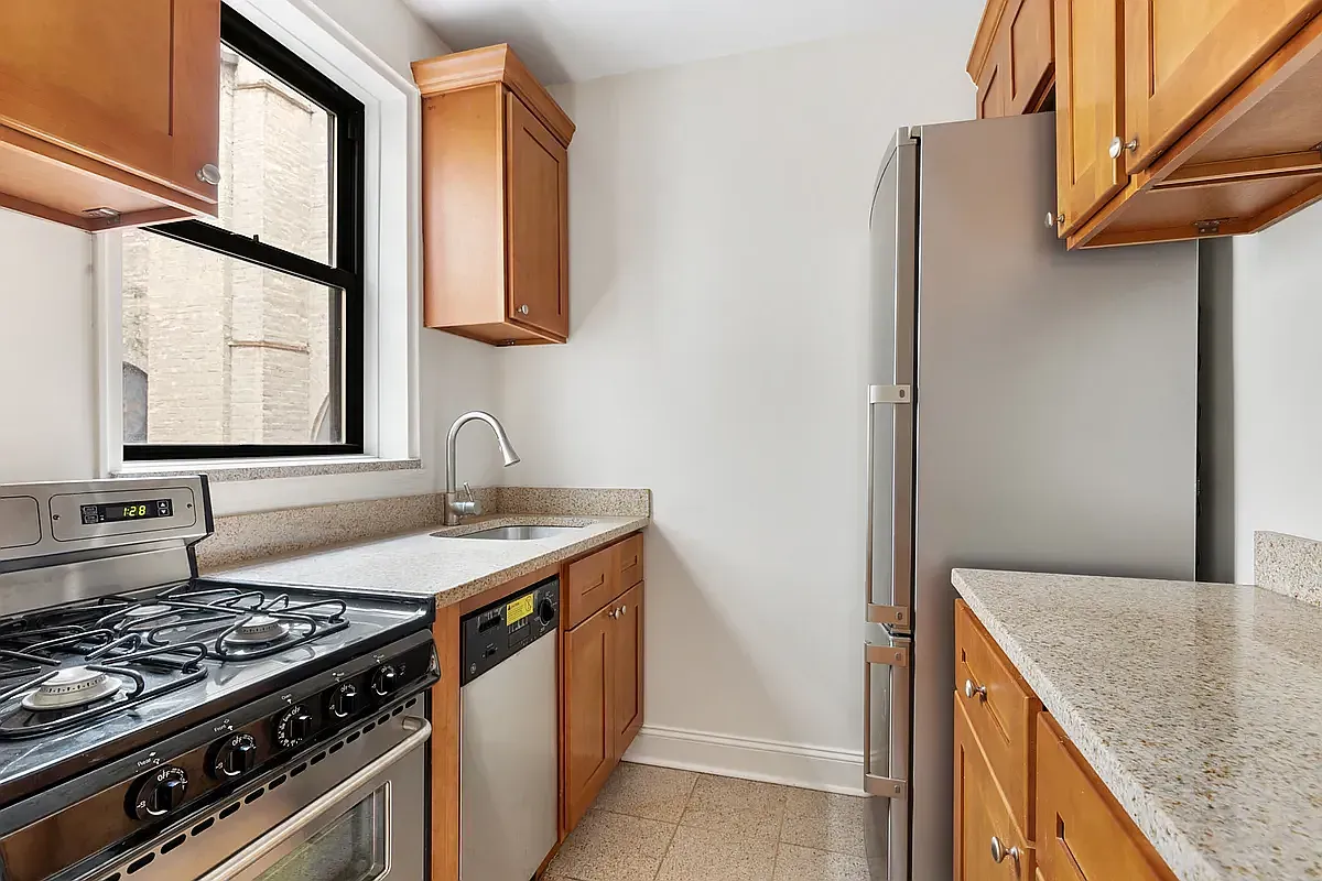 a kitchen with stainless steel appliances granite countertop a sink and a stove