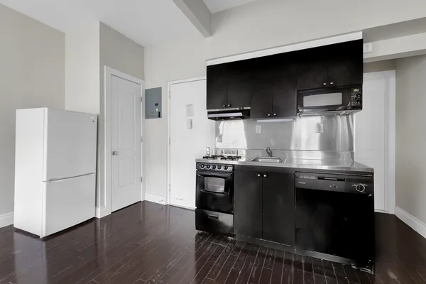 a kitchen with stainless steel appliances a microwave a stove and a microwave