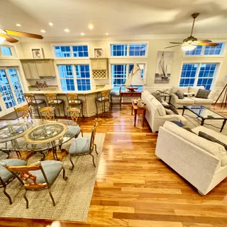 a living room with lots of furniture and kitchen view