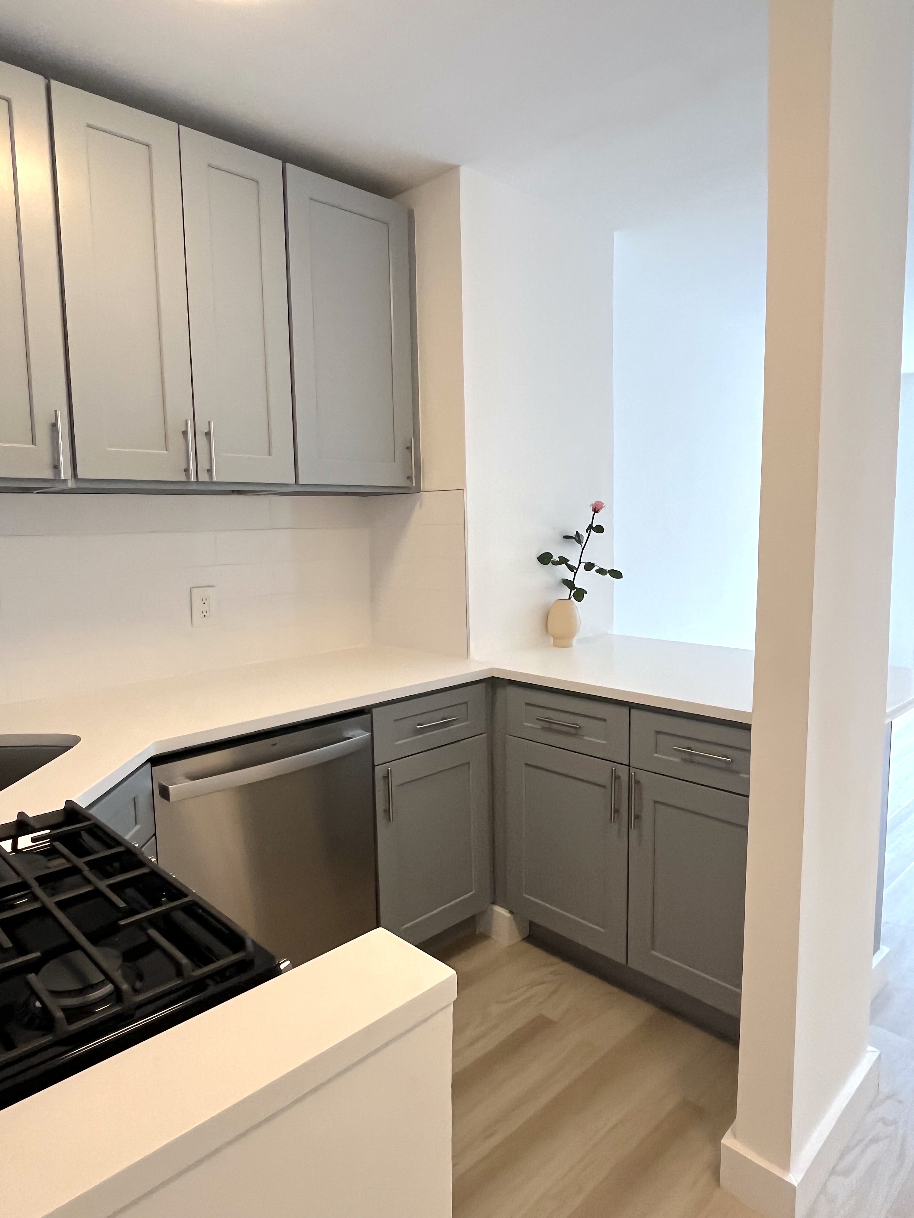 321 East 48th Street, Unit 10L Manhattan, NY 10017 - Photo 3 of 6 a kitchen with a sink and cabinets
