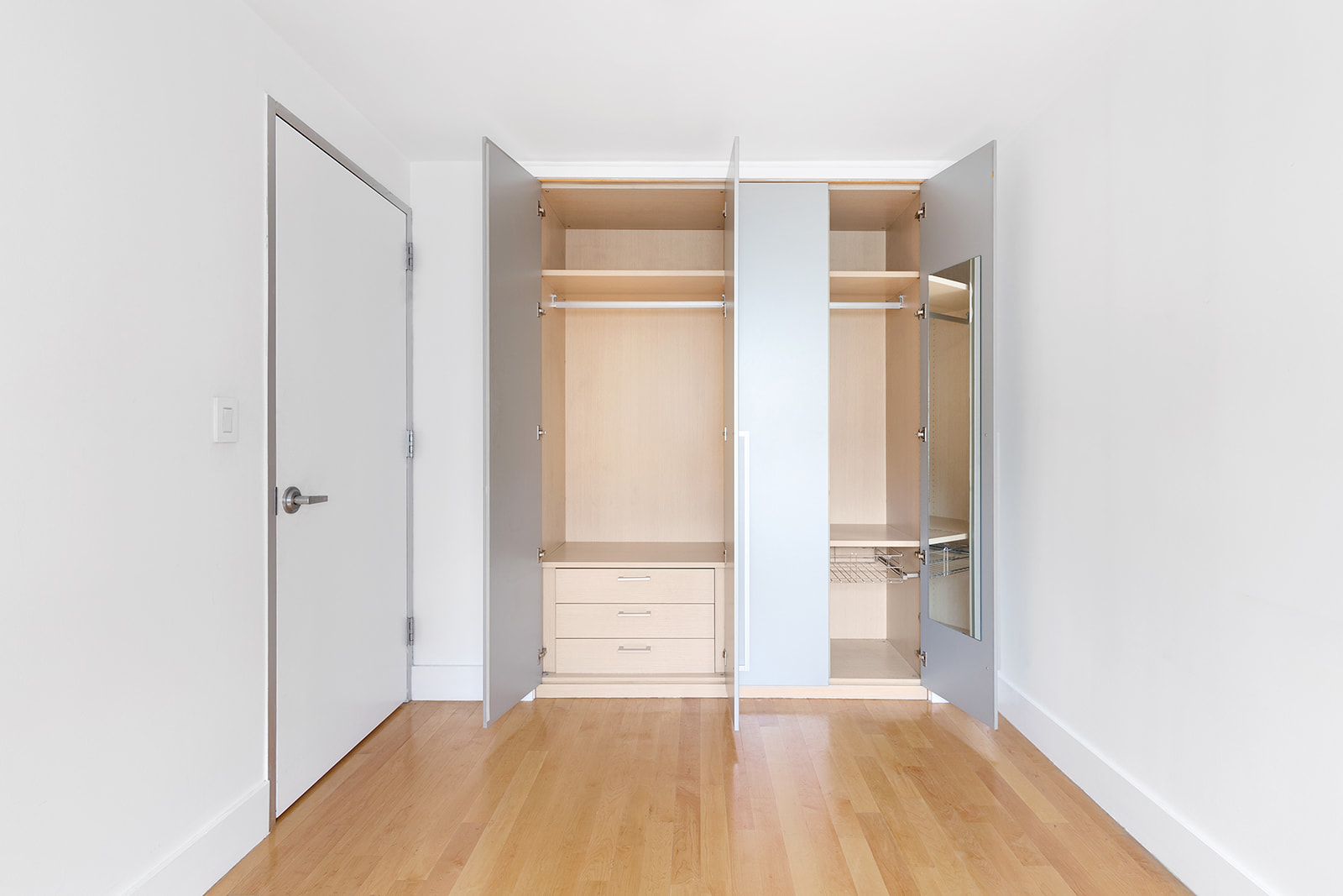 181 Hester Street, Unit 4A Manhattan, NY 10013 - Photo 5 of 8 a view of empty room with wooden floor