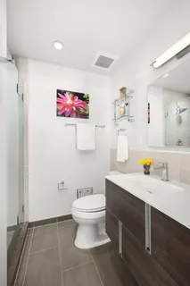 a bathroom with a sink a mirror and a toilet