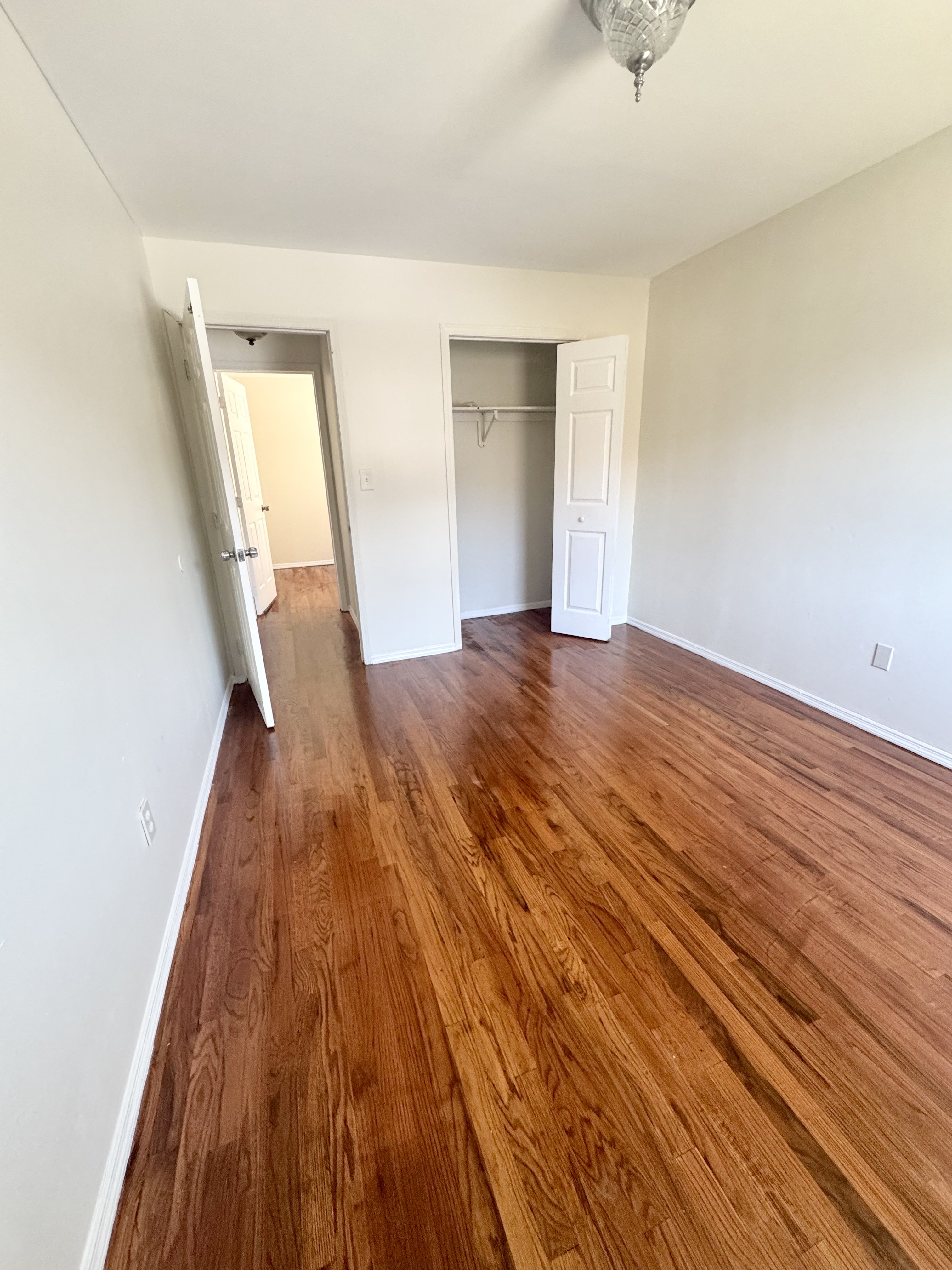156-17 76th Street, Unit 1 Queens, NY 11414 - Photo 9 of 12 a view of empty room with wooden floor