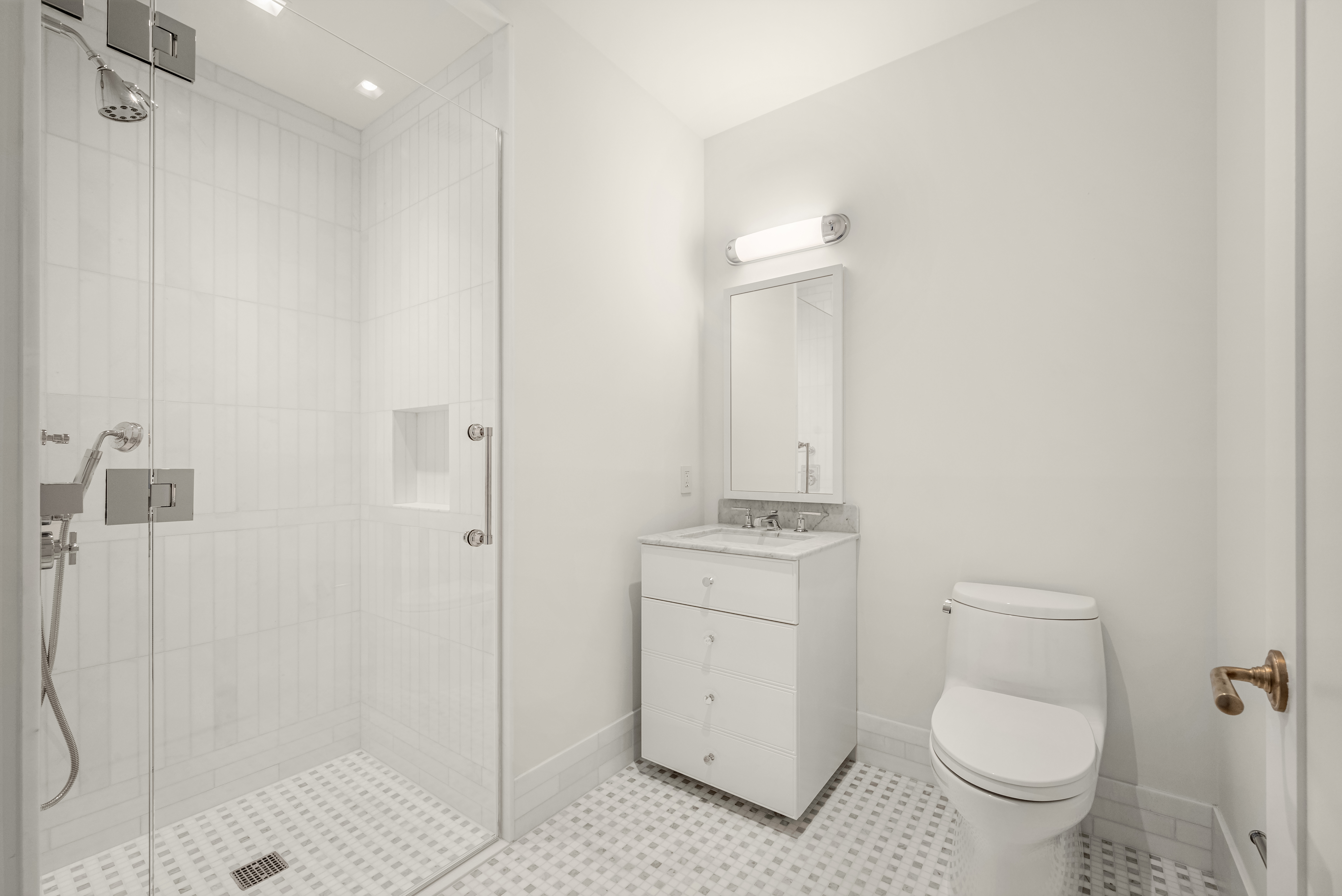 200 East 75th Street, Unit 6C Manhattan, NY 10021 - Photo 7 of 11 a bathroom with a granite countertop toilet a sink and a mirror
