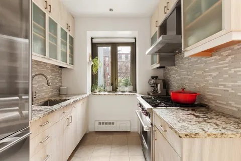 a kitchen with stainless steel appliances granite countertop a sink stove and cabinets
