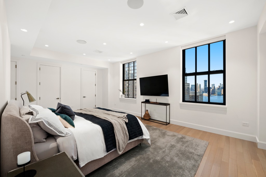 100 Barclay Street, Unit 21AD Manhattan, NY 10007 - Photo 12 of 40 a bedroom with a bed and a flat screen tv