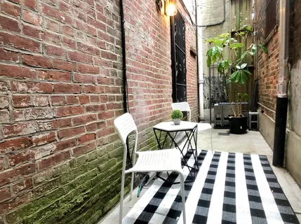 a view of a patio with a table and chairs