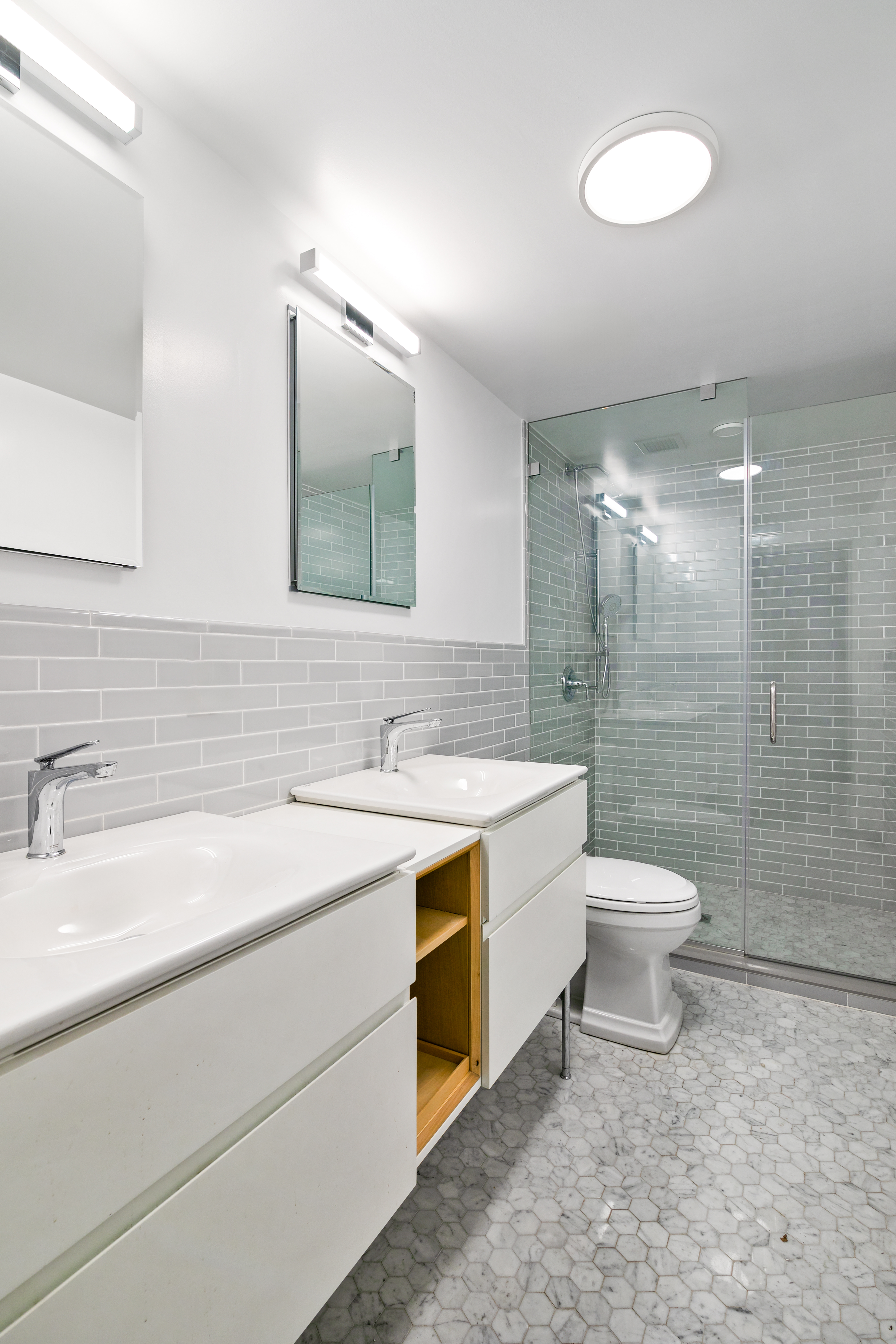 914 President Street, Unit TWNHSE Brooklyn, NY 11215 - Photo 11 of 29 a bathroom with a double vanity sink toilet and a mirror
