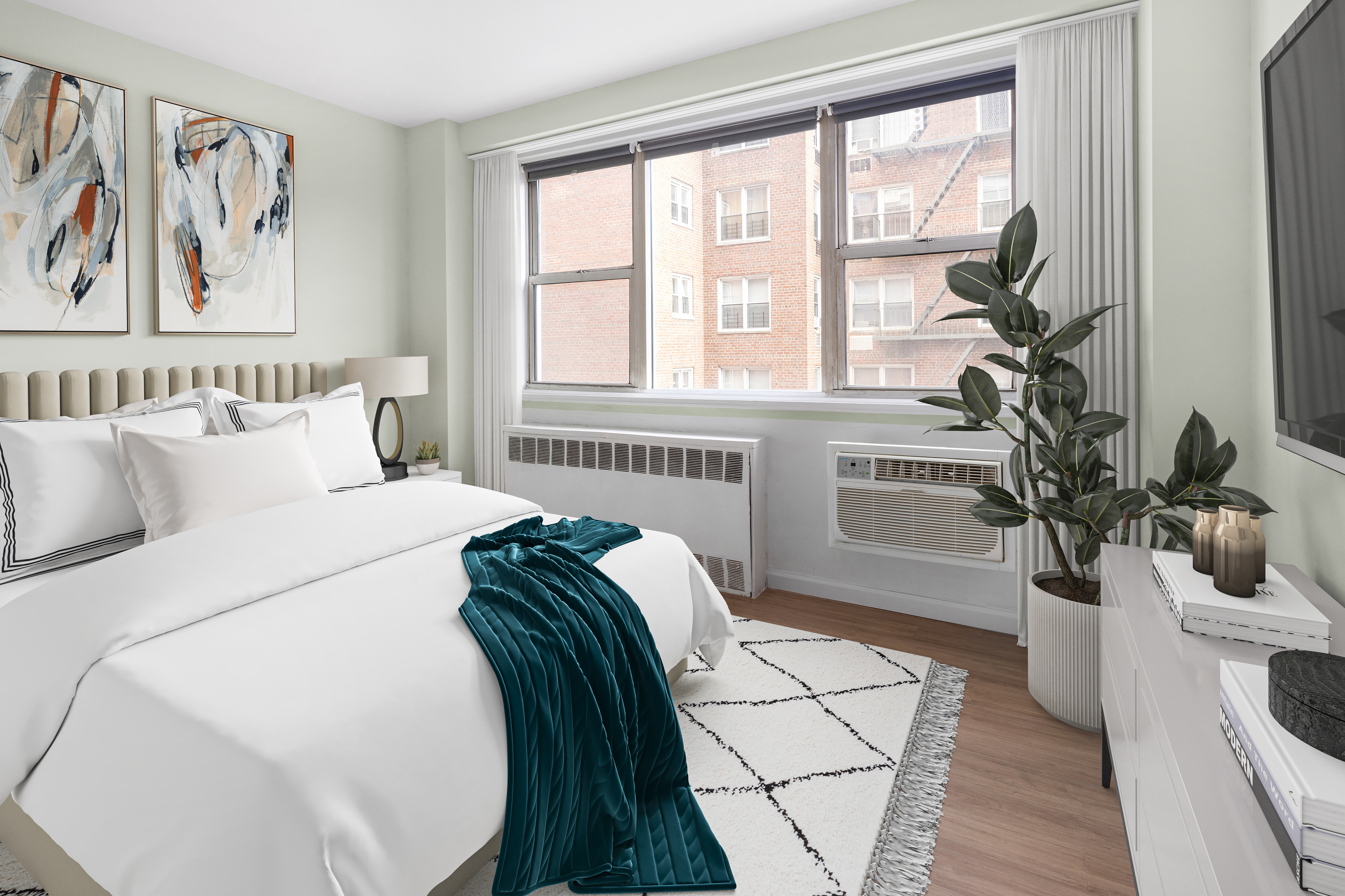 110-50 71st Road, Unit 5N Queens, NY 11375 - Photo 4 of 8 a bedroom with a bed a couch and a potted plant