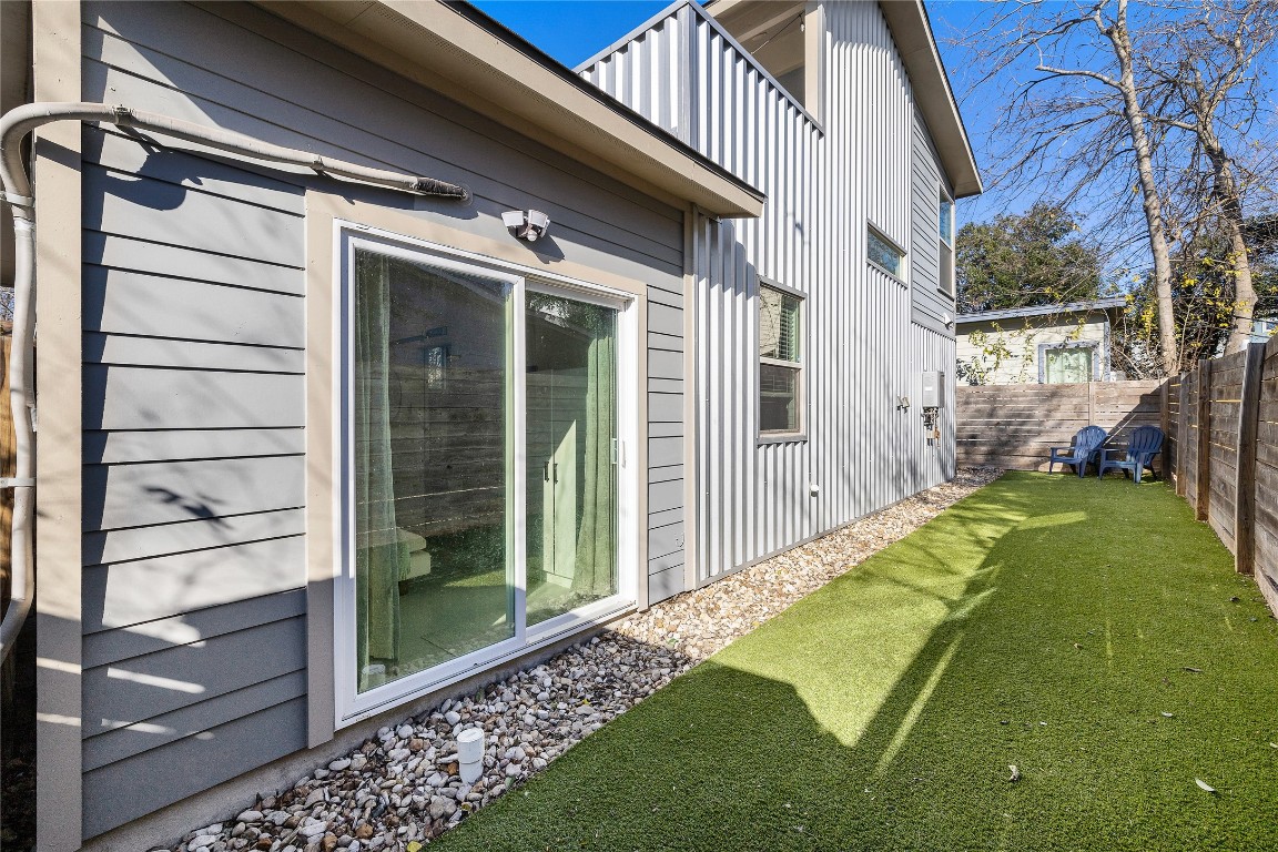 1402 Singleton Avenue, Unit B Austin, TX 78702 - Photo 24 of 26 a view of a balcony with a floor to ceiling window and wooden fence