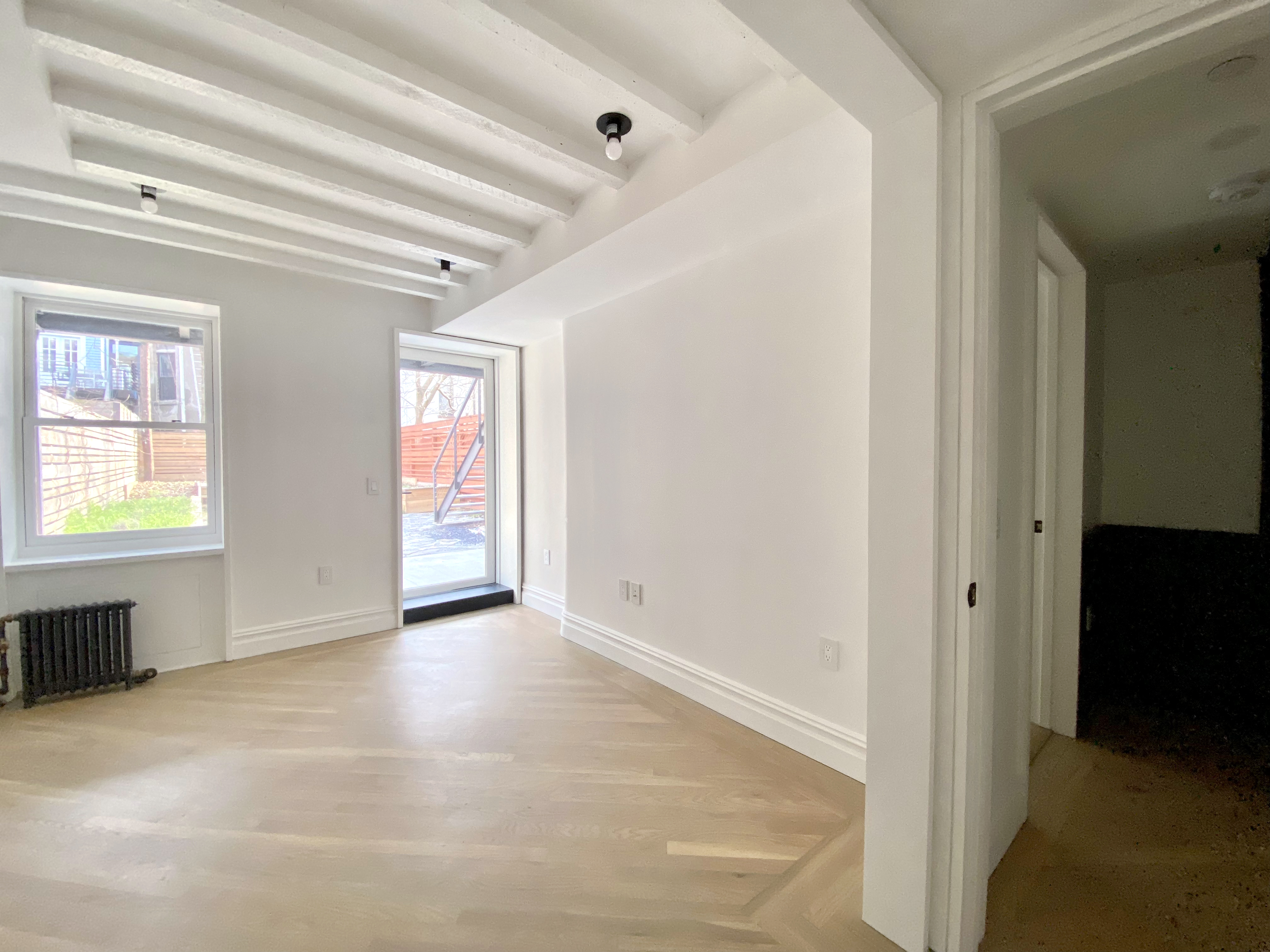 1420 Pacific Street, Unit 1 Brooklyn, NY 11216 - Photo 21 of 30 a view of an empty room with window and a kitchen