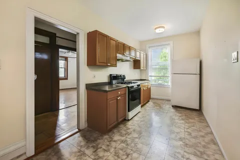 a kitchen with stainless steel appliances granite countertop a refrigerator stove and sink