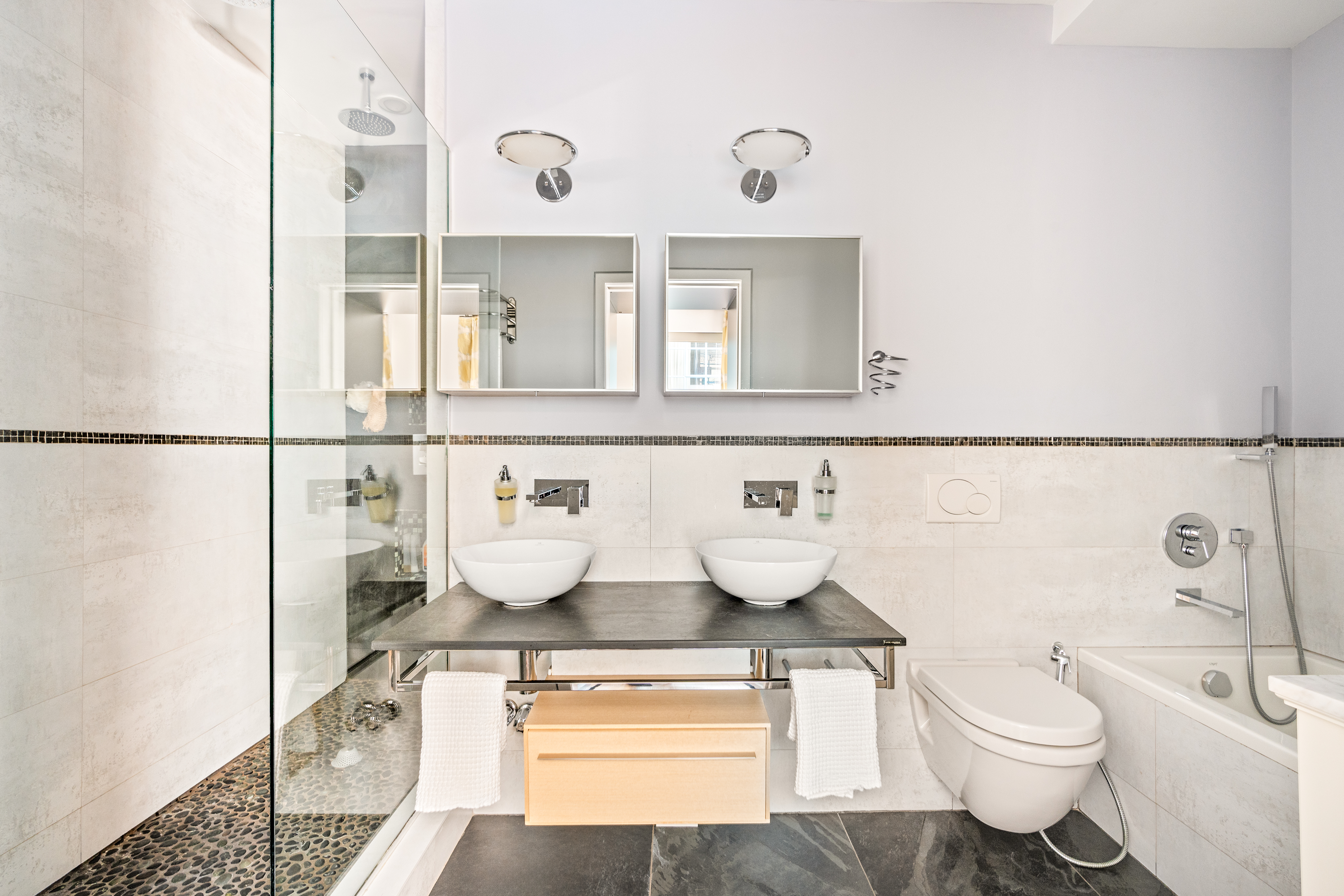 160 Chambers Street, Unit 3 Manhattan, NY 10007 - Photo 6 of 9 a bathroom with a toilet a sink and a mirror