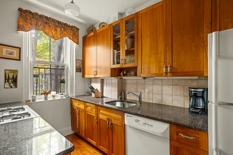 a kitchen with a stove a sink and a refrigerator