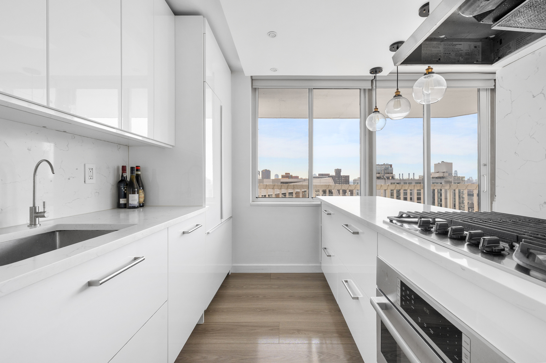 50 Lexington Avenue, Unit 25E Manhattan, NY 10010 - Photo 7 of 13 a kitchen with a sink a stove cabinets and white appliances