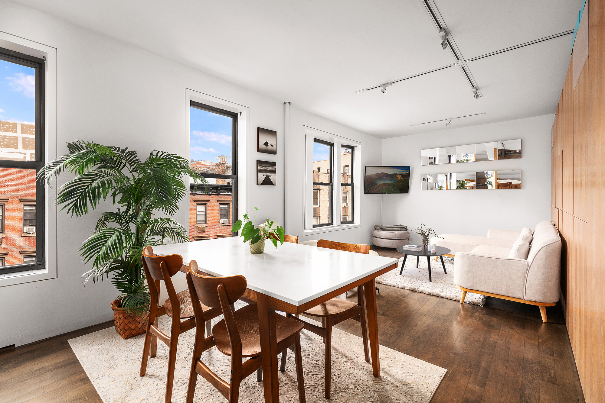 a view of a dining room with furniture and wooden floor