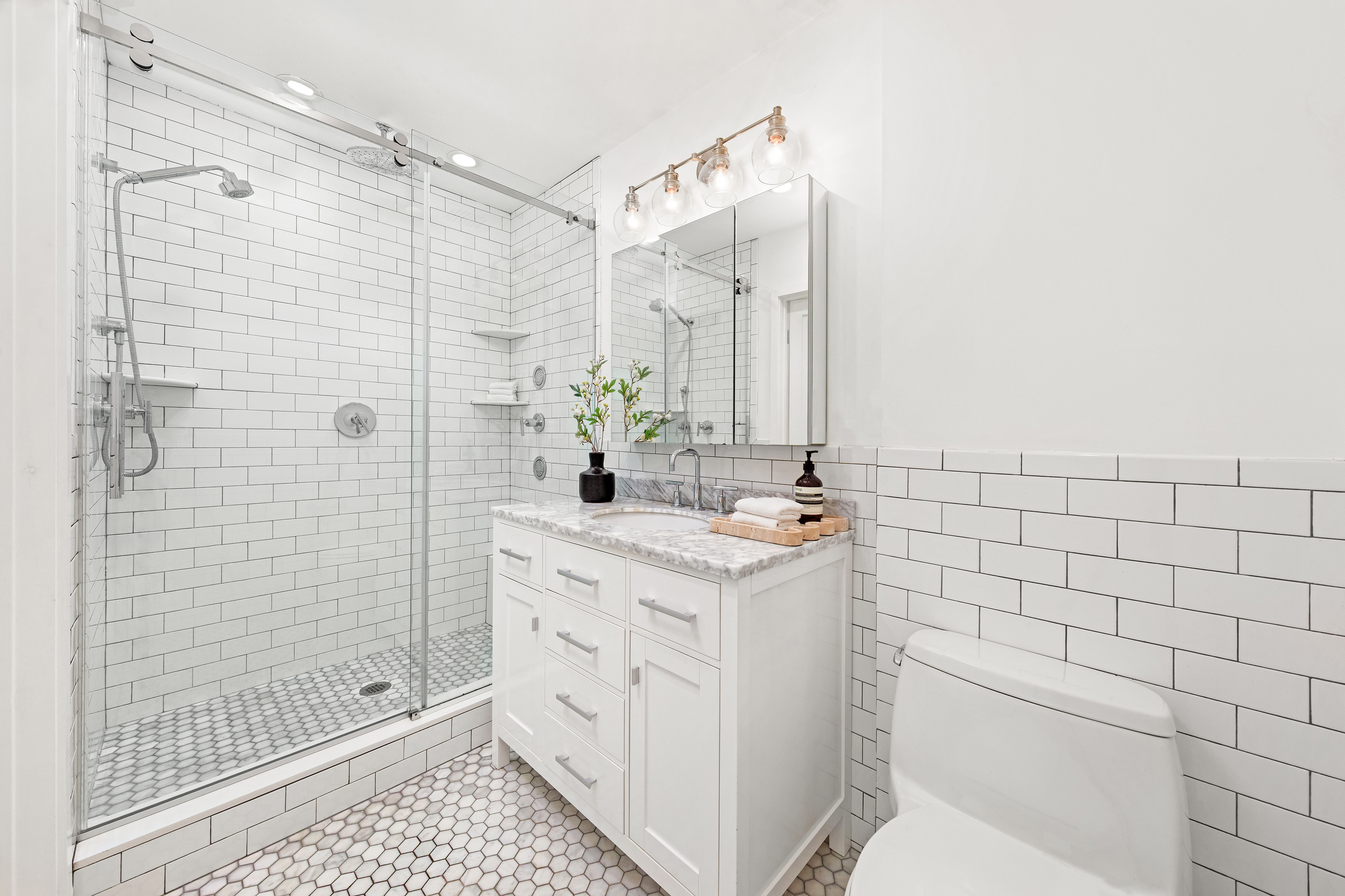 31 West 93rd Street, Unit 1D Manhattan, NY 10025 - Photo 8 of 18 a bathroom with a sink a toilet and shower