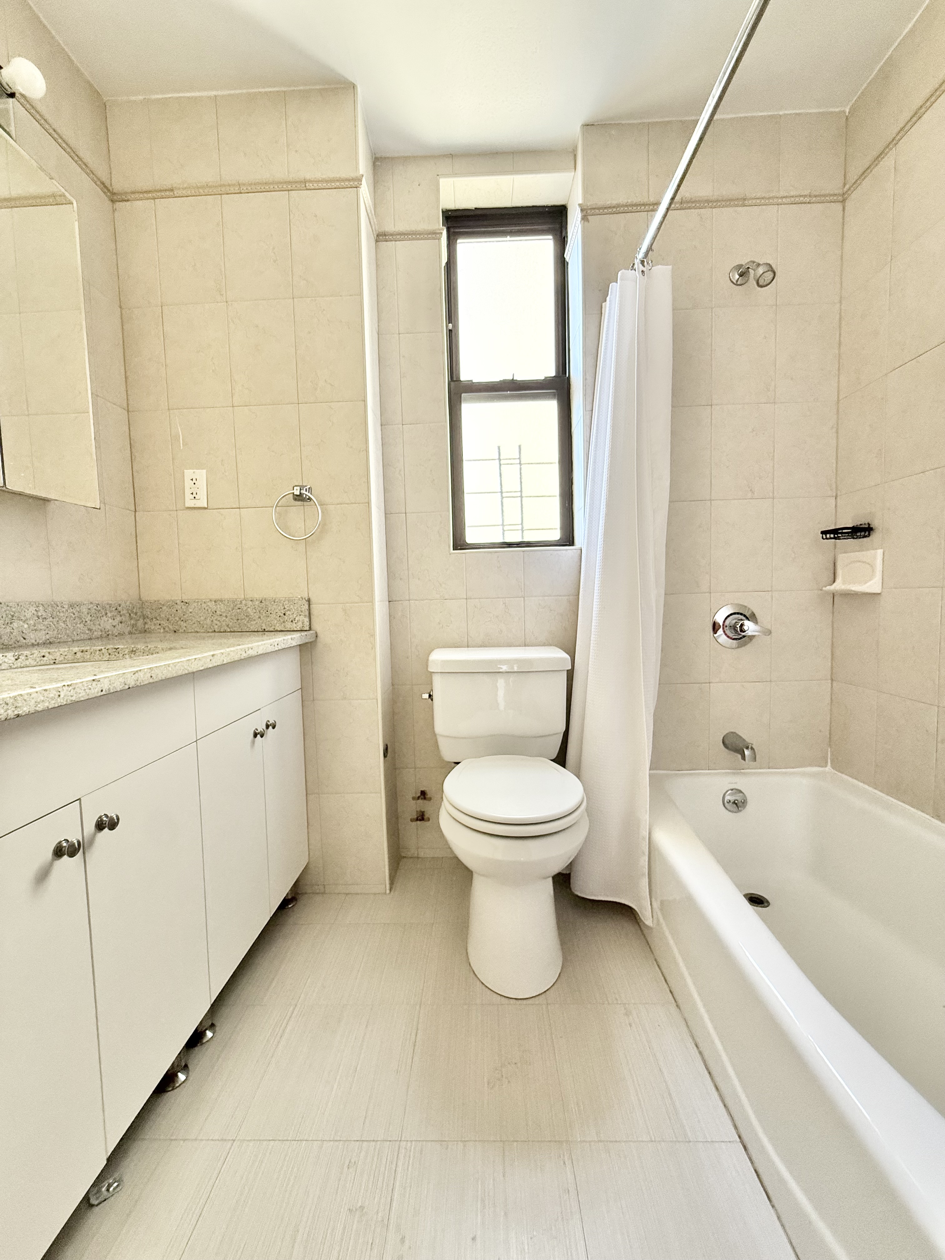 675 West End Avenue, Unit 12A Manhattan, NY 10025 - Photo 13 of 15 a white toilet sitting next to a bathroom sink