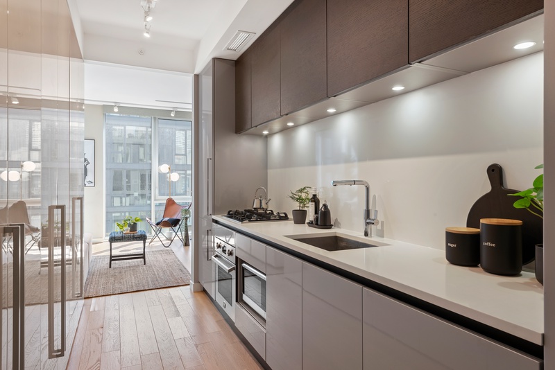 540 West 49th Street, Unit 609N Manhattan, NY 10019 - Photo 6 of 10 a kitchen with sink and view of living room