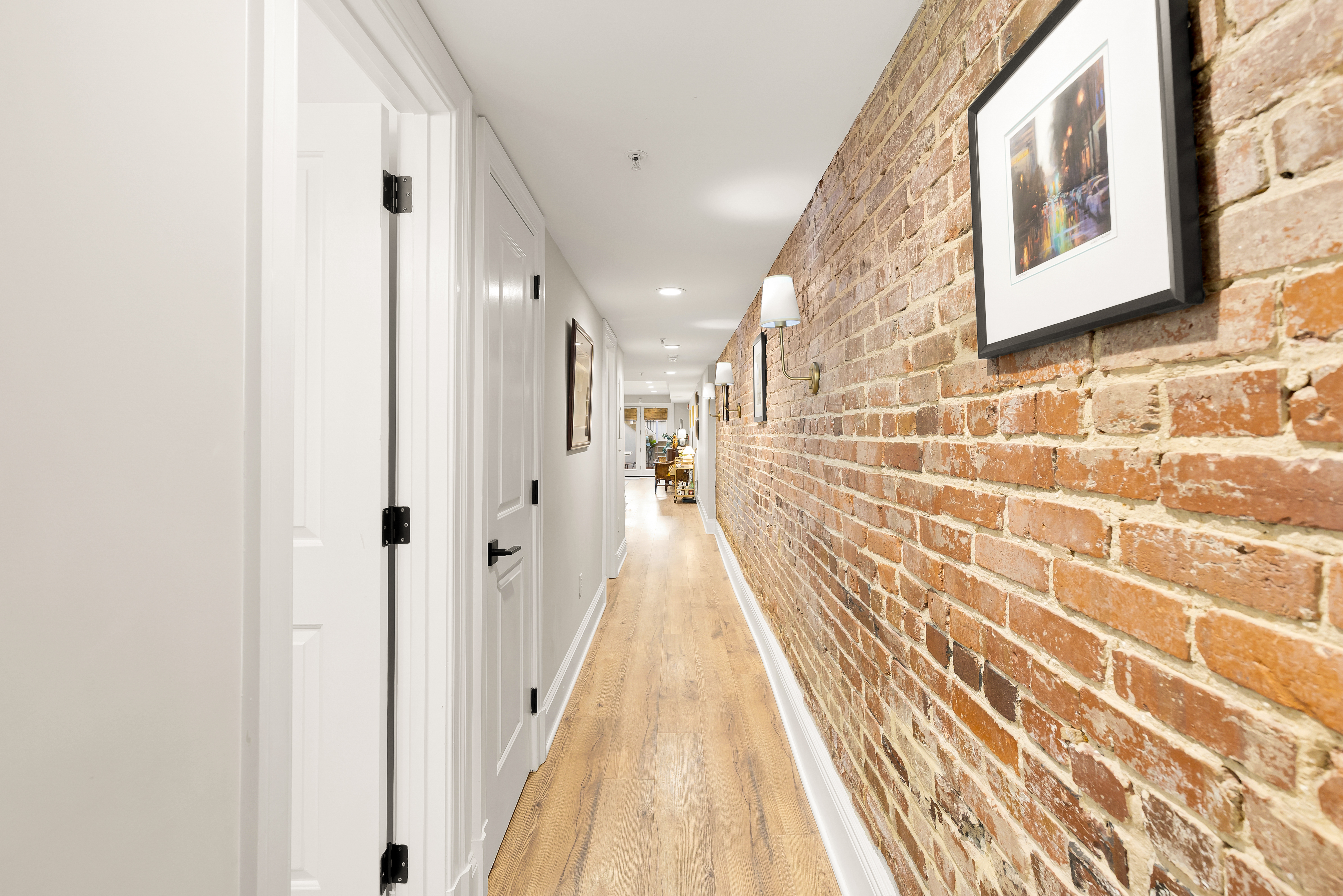 1354 Kenyon Street Northwest, Unit G Washington, DC 20010 - Photo 25 of 35 a view of a hallway with wooden floor and a bathroom