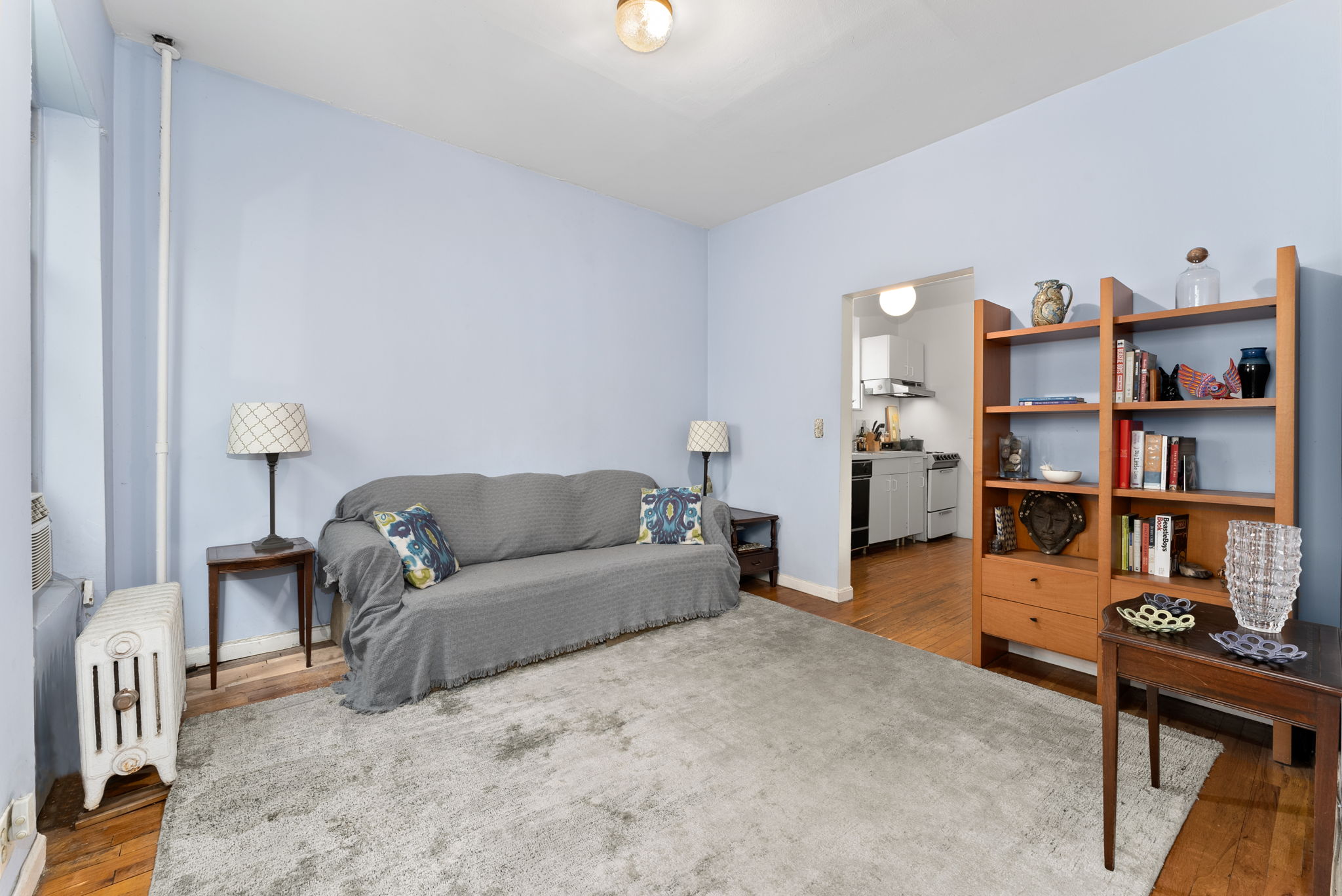 311 Henry Street, Unit 3 Brooklyn, NY 11201 - Photo 4 of 10 a living room with furniture and a book shelf