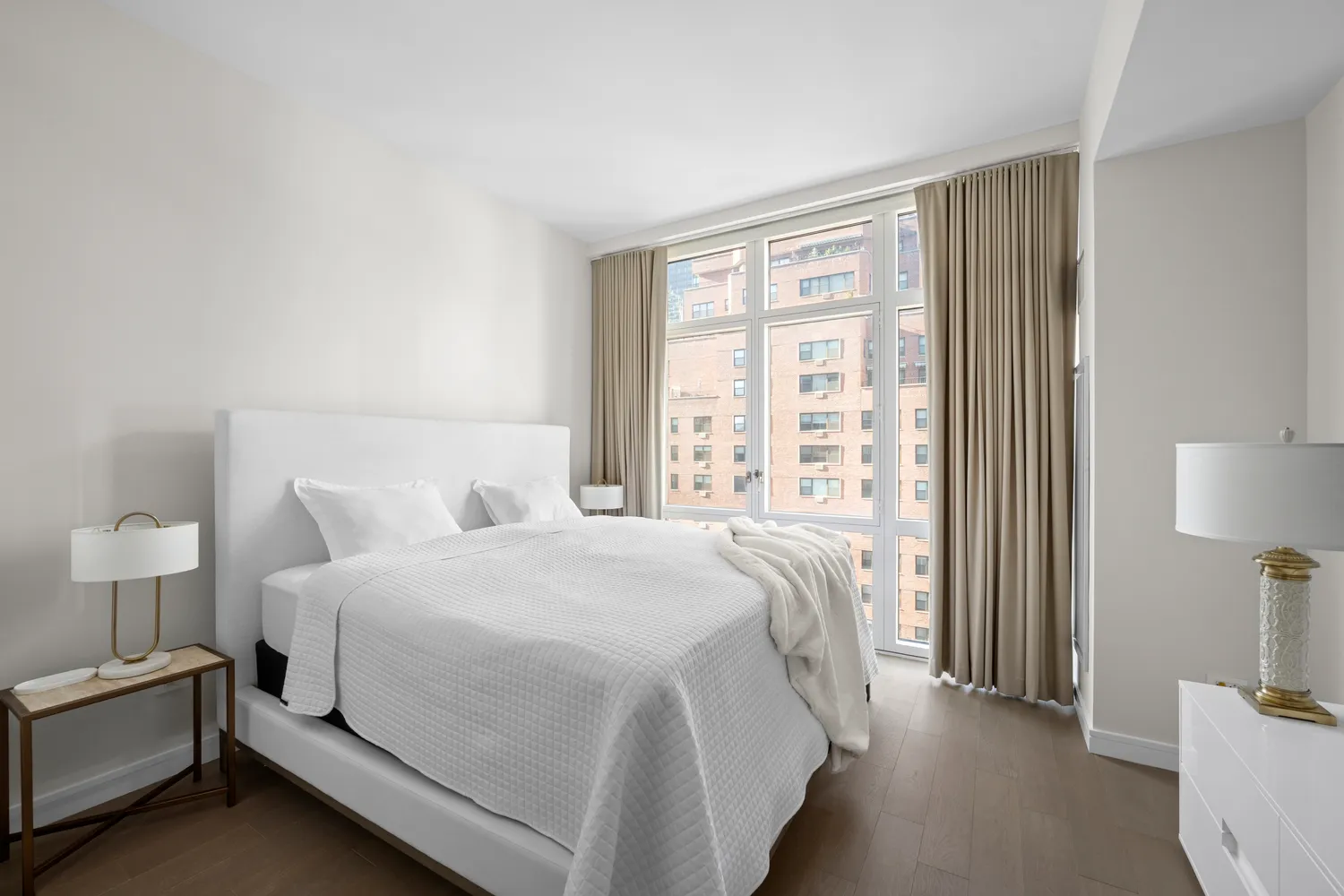 a bedroom with a bed and a lamp on table