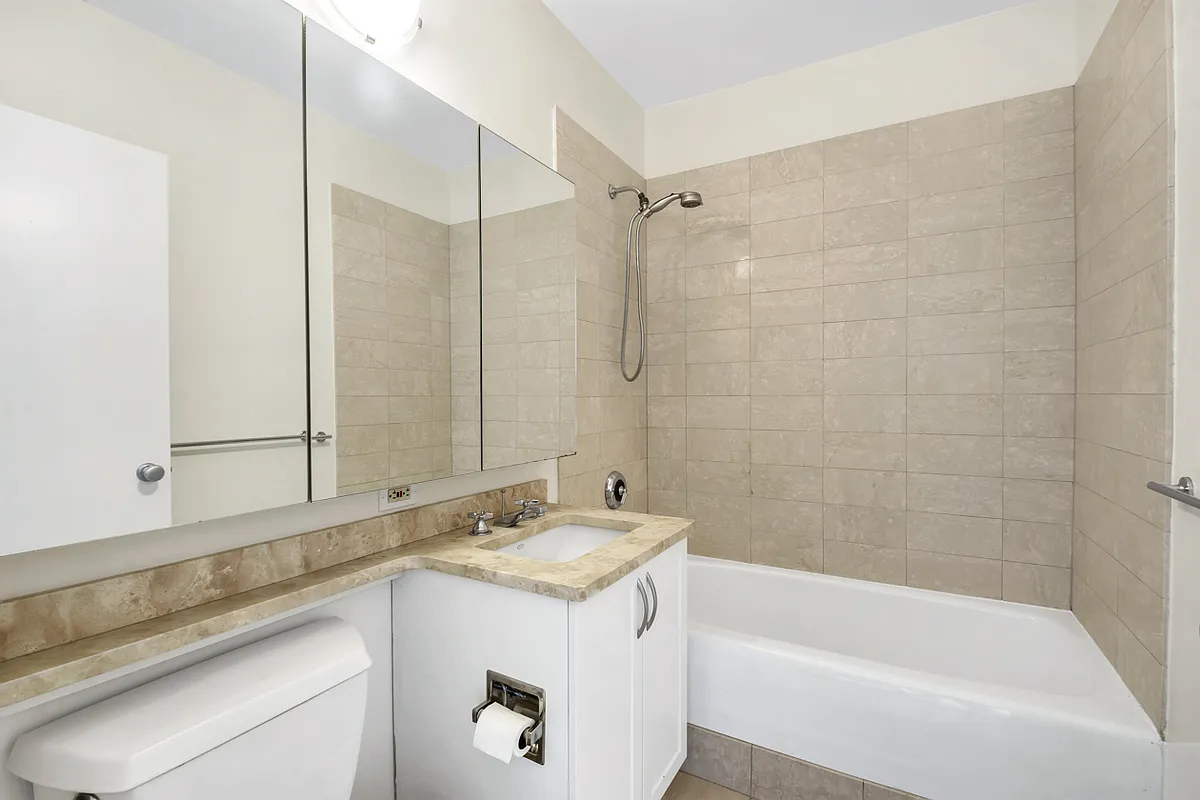 250 East 30th Street, Unit 10H Manhattan, NY 10016 - Photo 2 of 9 a bathroom with a sink and a bathtub