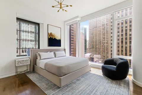 a bedroom with a bed couch and window