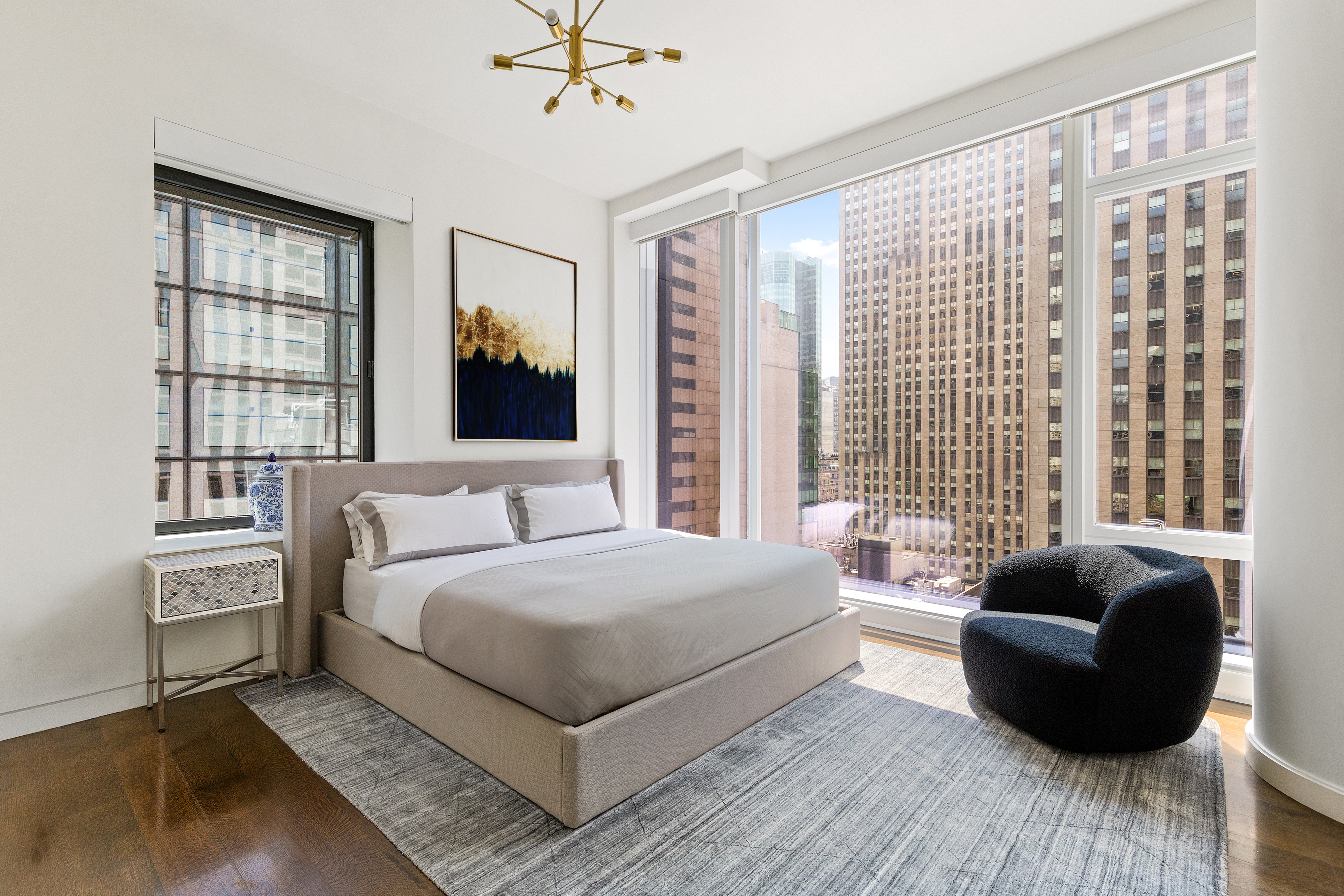 20 West 53rd Street, Unit 22A Manhattan, NY 10019 - Photo 7 of 16 a bedroom with a bed couch and window