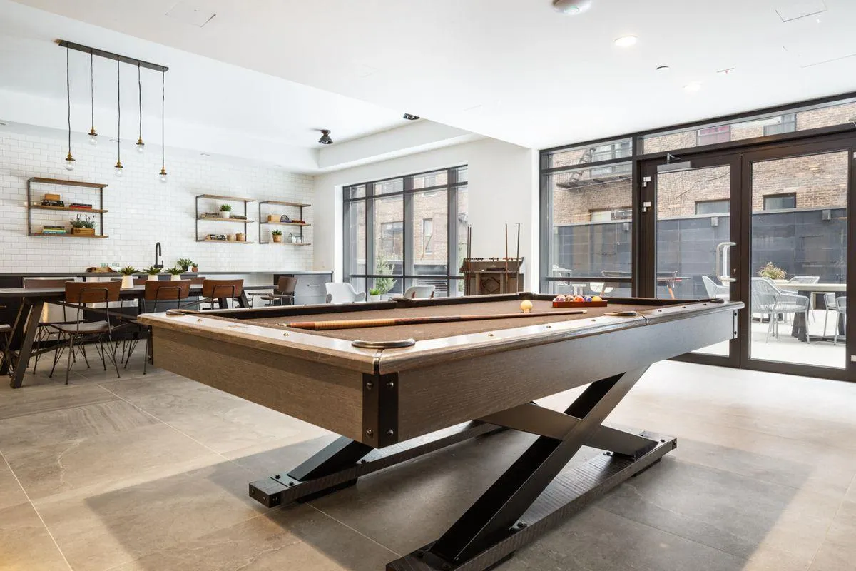 a living room with windows pool table and a large window