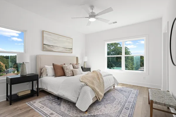 a bedroom with a bed a couch and a window