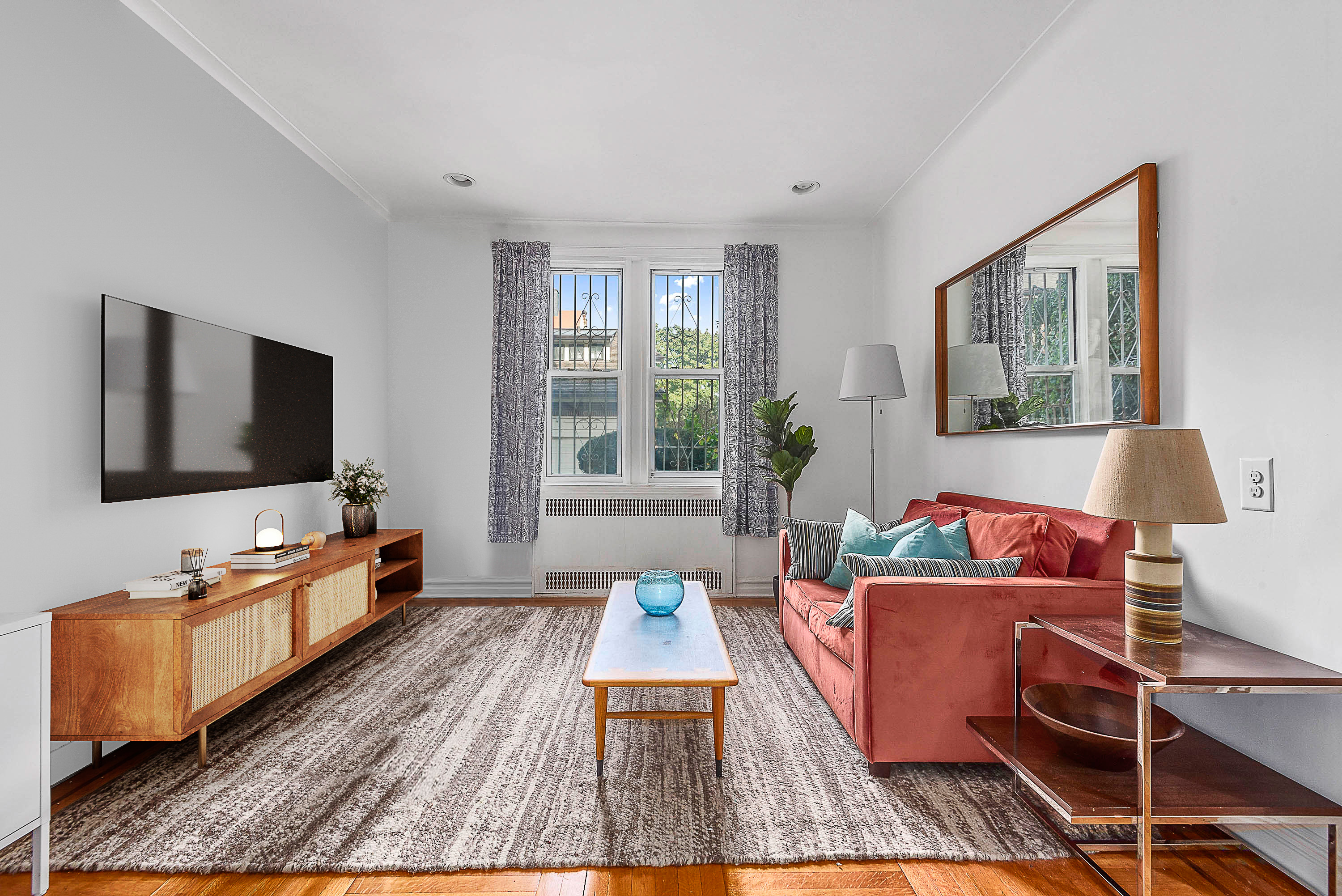 1409 Albemarle Road, Unit 1H Brooklyn, NY 11226 - Photo 1 of 9 a living room with furniture and a flat screen tv
